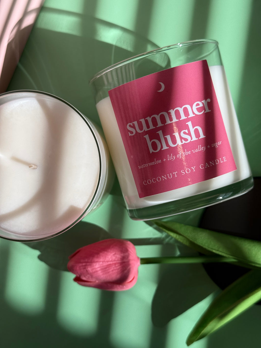 Candle with 'summer blush' label on a green background